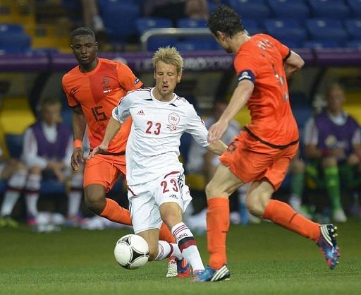 Danish forward Tobias Mikkelsen (C) vies with Dutch player Mark van Bommel (R) and Jetro Willems